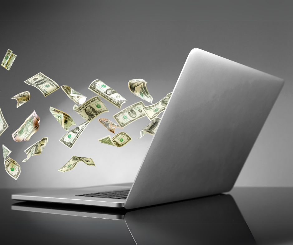 money flying into laptop to illustrate tech debt